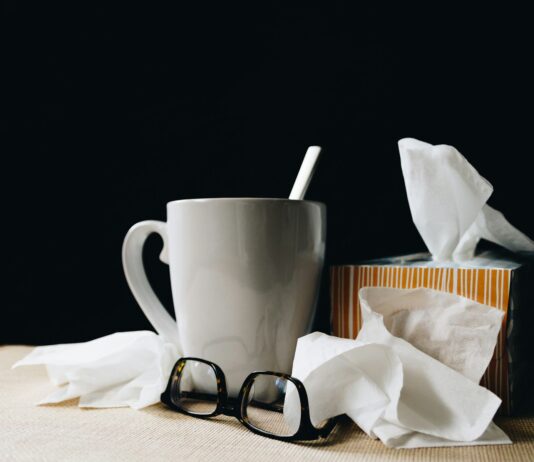독감과 감기의 차이: 정확히 알고 대처하자 white ceramic mug on white table beside black eyeglasses