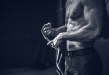 “근육이 곧 건강의 척도”… ‘근육 건강’이 새로운 라이프스타일 키워드로 뜬다 a shirtless man holding a pair of gloves