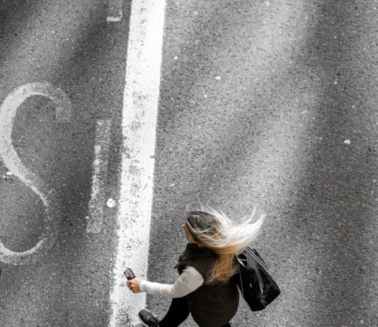 “작지만 소중한 쉼, 일상 속 정신건강 지키는 새로운 흐름” woman in black jacket and black pants walking on gray asphalt road during daytime