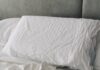 수면의 질 높이기, 일상에서 실천할 수 있는 건강 루틴 주목받아 A rumpled white duvet and pillows on a bed.